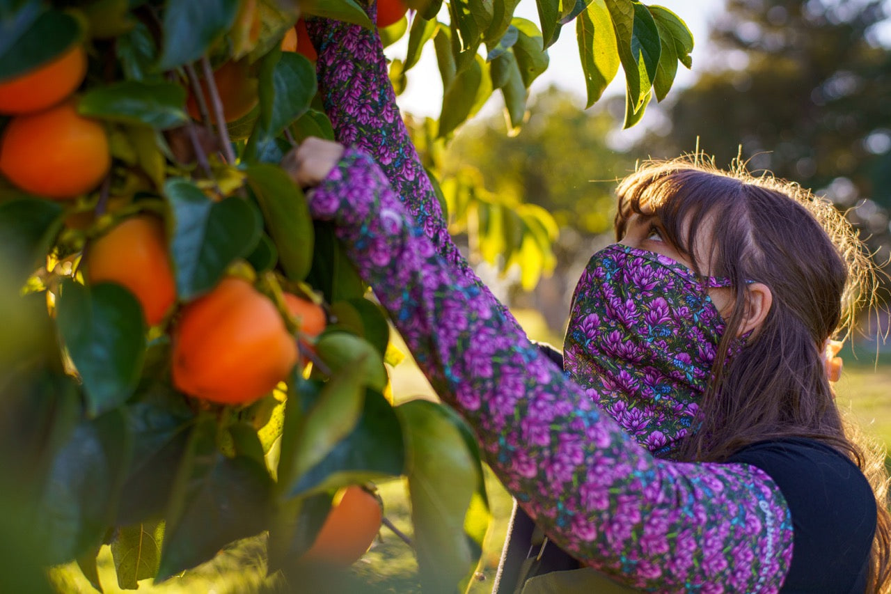 A woman picking winter fruit.