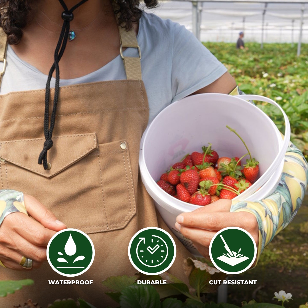 Woman wearing Farmers Defense canvas apron holding strawberries. Product callouts with icons mention waterproof, durable, cut-resistant product descriptions