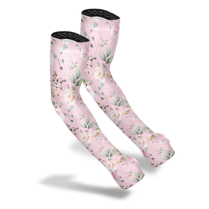 Farmers Defense Breast Cancer Awareness Sleeves feature a pink background, green leaves, and hummingbirds buzzing around carnation flowers.